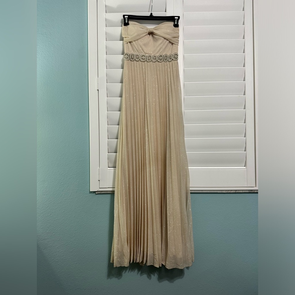 cream colored strapless prom dress, sparky details and beaded features